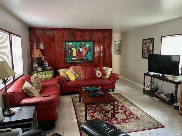 a living room with furniture a rug and a flat screen tv