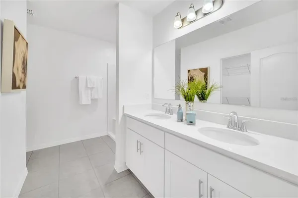 a bathroom with a double vanity sink and a mirror