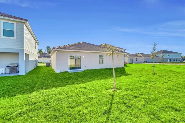 a view of a house with a yard and sitting area