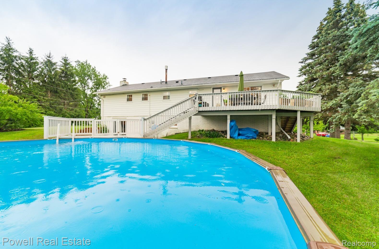 100 Gilmour Road Leonard, MI 48367 - Photo 25 of 29 THIS ABOVE GROUND POOL ... FEELS ALMOST LIKE AN INFINITY POOL WHEN YOU SEE IT FROM THE DECK!