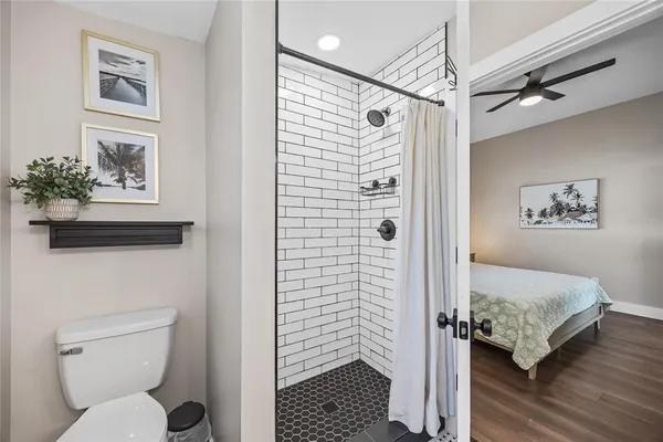 a en suite bathroom with a granite countertop double vanity sink a mirror and a shower
