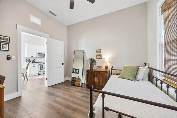 a bedroom with furniture and a wooden floor
