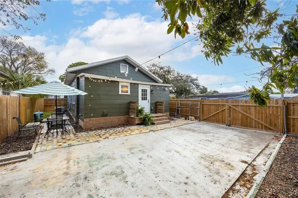 a view of a house with wooden fence