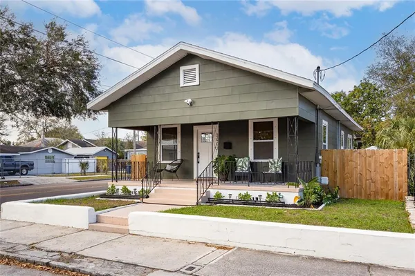 a front view of house with outdoor seating and yard