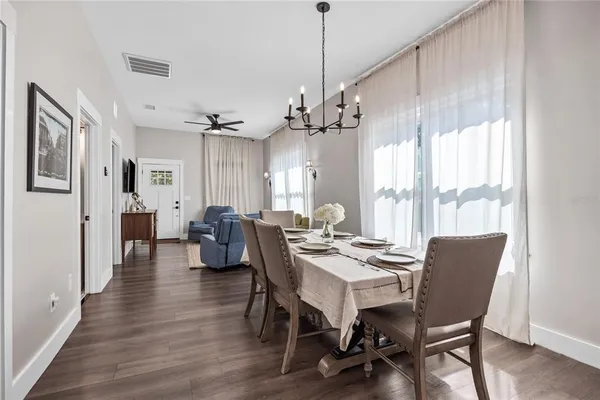 a view of a dining room with furniture window and wooden floor