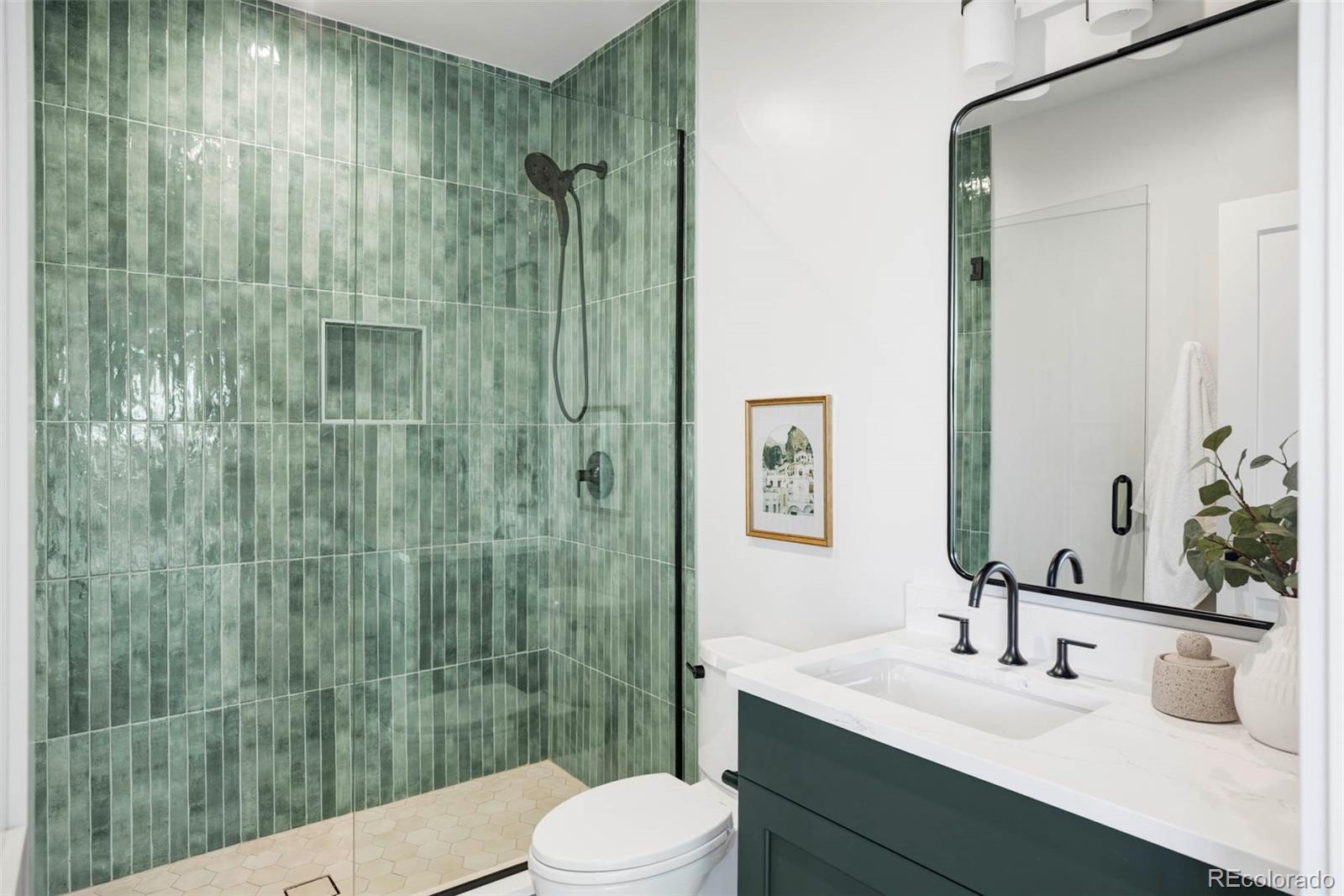 295 Kearney Street Denver, CO 80220 - Photo 19 of 41 a bathroom with a sink a toilet and shower