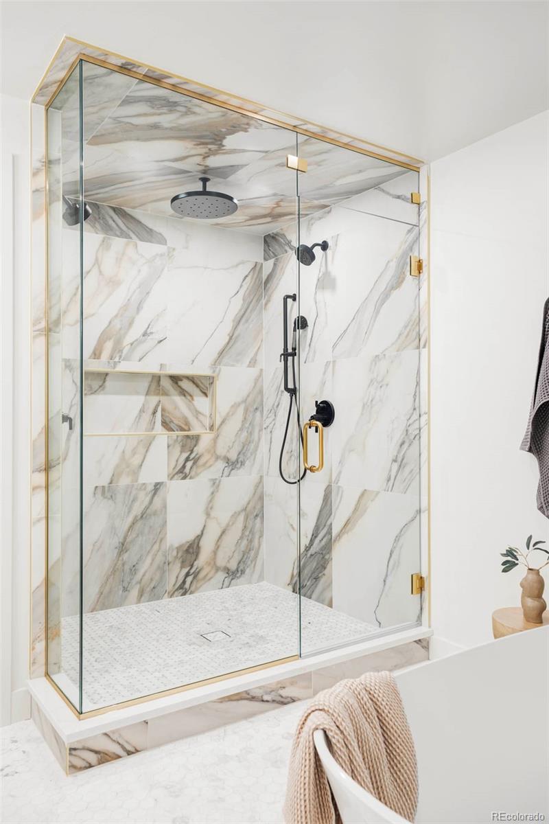 295 Kearney Street Denver, CO 80220 - Photo 21 of 39 a bathroom with a bathtub and a shower