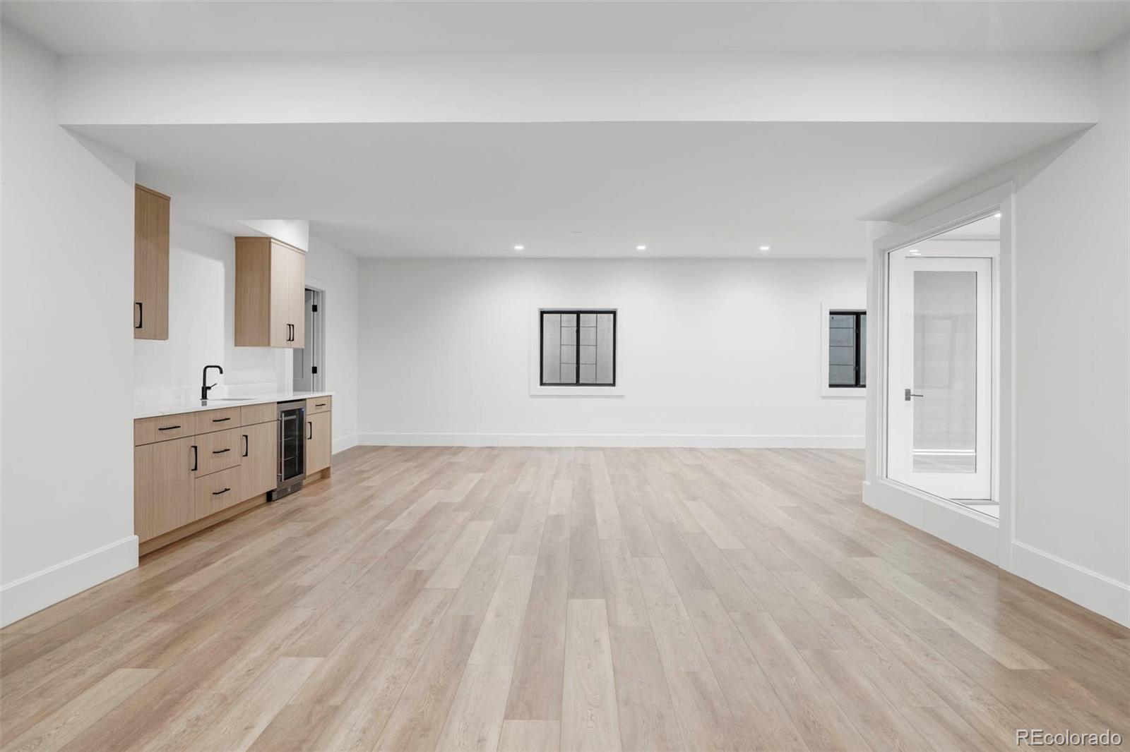 295 Kearney Street Denver, CO 80220 - Photo 36 of 41 an empty room with wooden floor and windows
