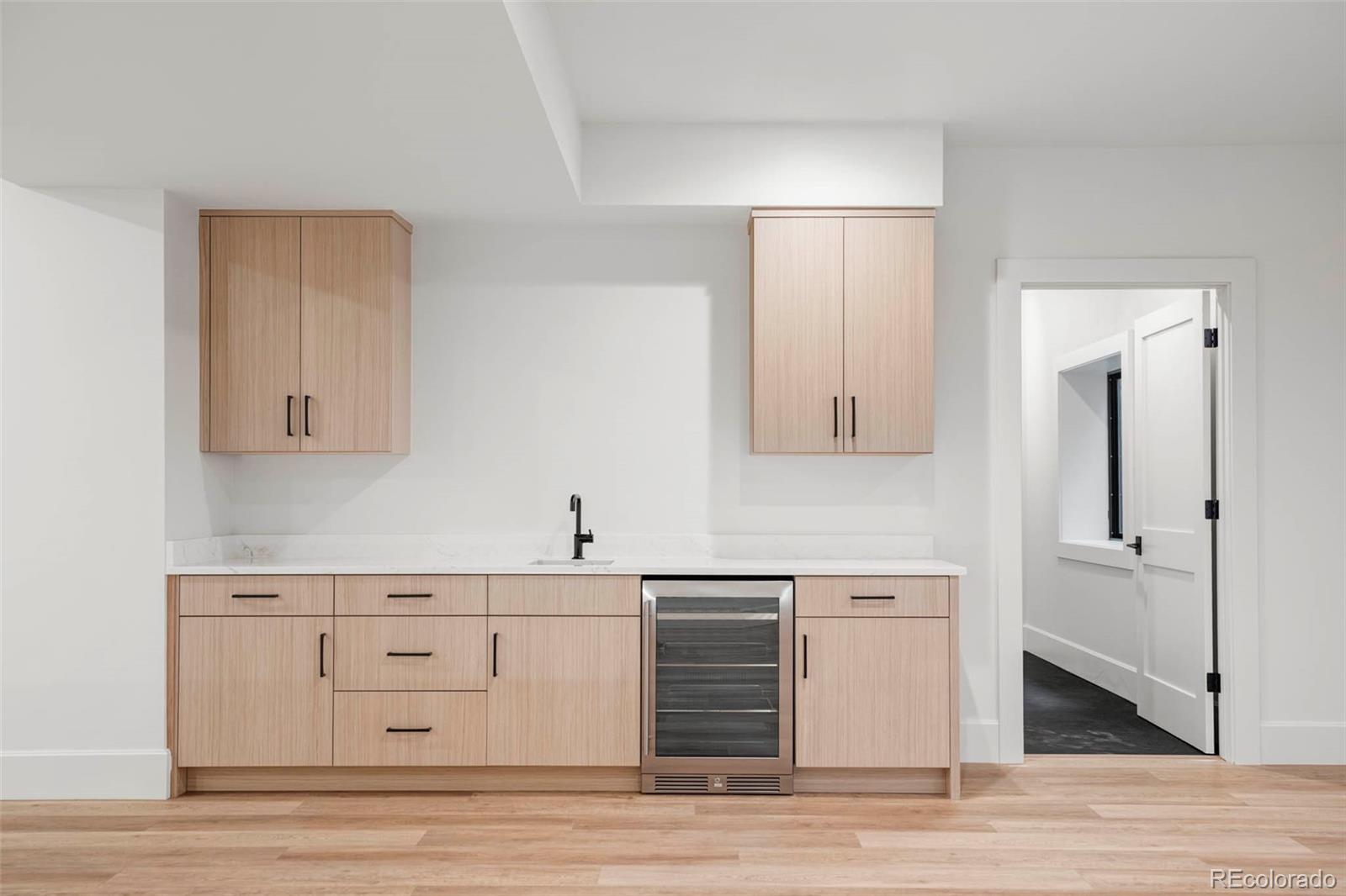 295 Kearney Street Denver, CO 80220 - Photo 36 of 39 a view of cabinets a wooden floor and a sink in a room