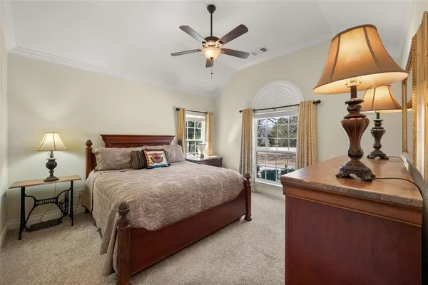 a bedroom with a bed and window