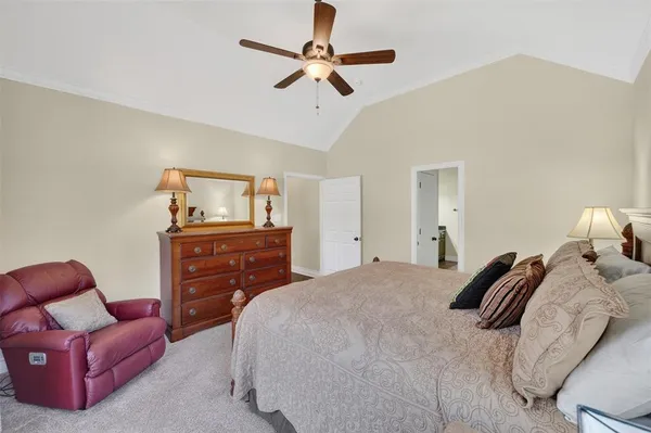 a bedroom with a bed and a couch