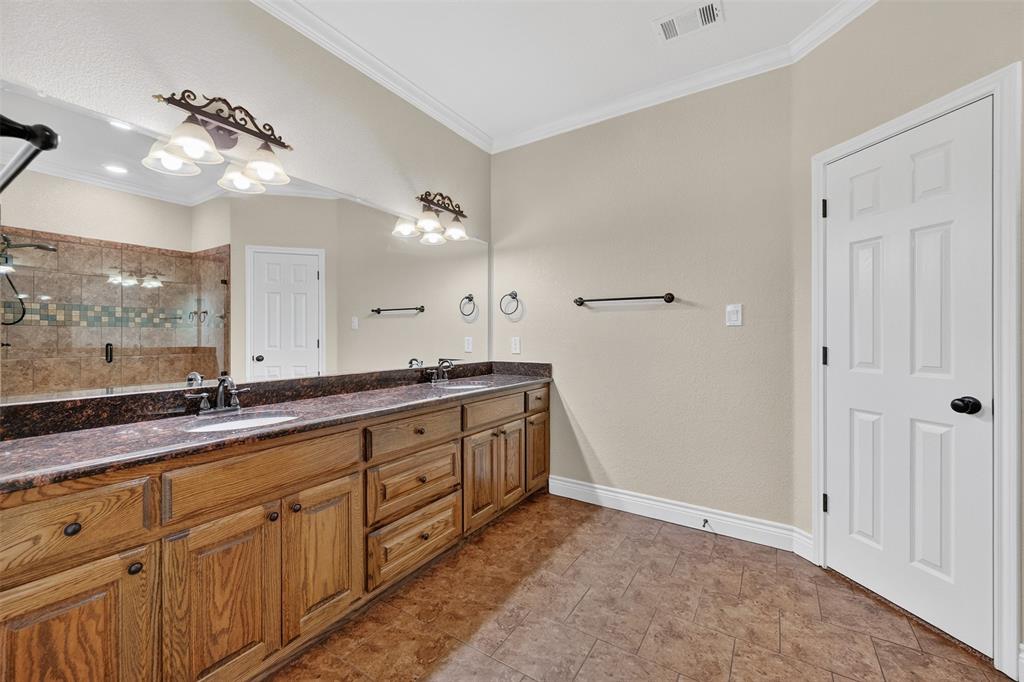 403 Arrowhead Point Kerens, TX 75144 - Photo 22 of 40 a spacious bathroom with a granite countertop double vanity sink a mirror and shower