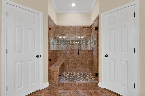 a view of a bathroom with a glass shower door