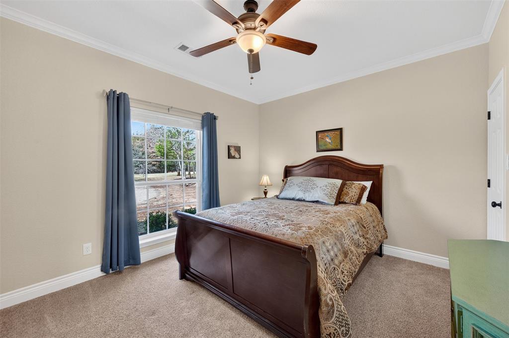 403 Arrowhead Point Kerens, TX 75144 - Photo 26 of 40 a bedroom with a bed and a chandelier