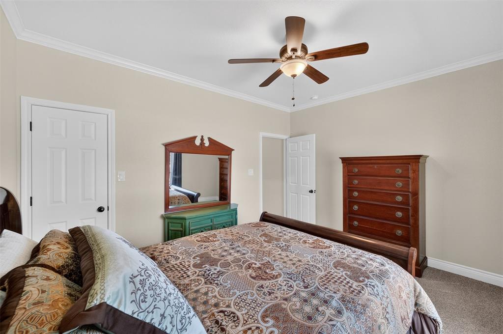 403 Arrowhead Point Kerens, TX 75144 - Photo 27 of 40 a bedroom with a bed and a dresser