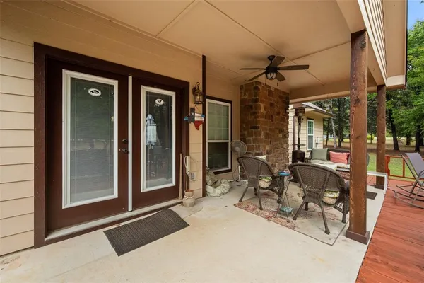 a view of a patio with table and chairs and potted plants