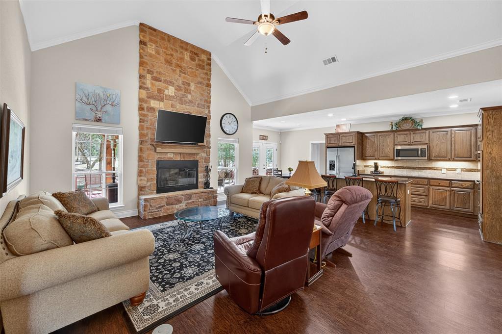 403 Arrowhead Point Kerens, TX 75144 - Photo 5 of 40 a living room with furniture kitchen view and a fireplace