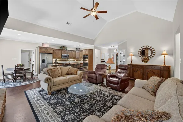 a living room with furniture ceiling fan and a rug