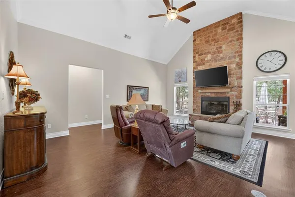 a living room with furniture a flat screen tv and a fireplace