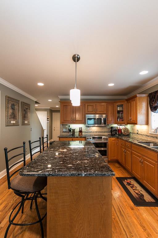 1232 Sugar Flat Road Lebanon, TN 37087 - Photo 12 of 30 a kitchen with stainless steel appliances granite countertop a stove top oven a sink counter space and living room view