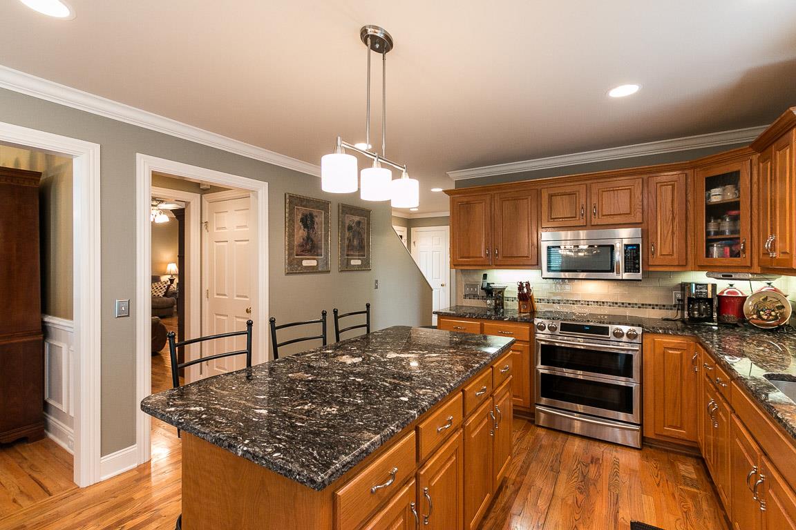 1232 Sugar Flat Road Lebanon, TN 37087 - Photo 13 of 30 a kitchen with stainless steel appliances granite countertop a stove top oven a sink dishwasher a refrigerator and cabinets with wooden floor