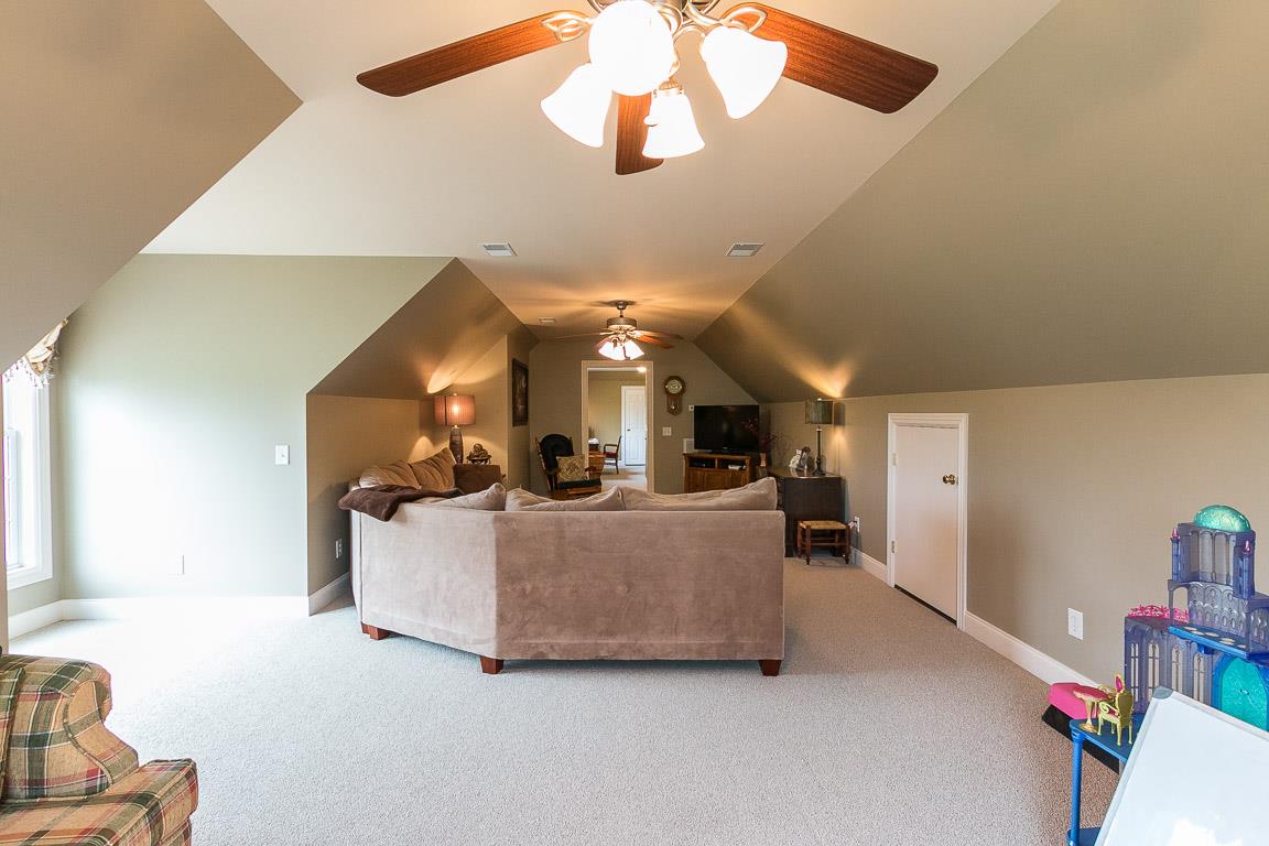1232 Sugar Flat Road Lebanon, TN 37087 - Photo 28 of 30 a living room with furniture and a chandelier