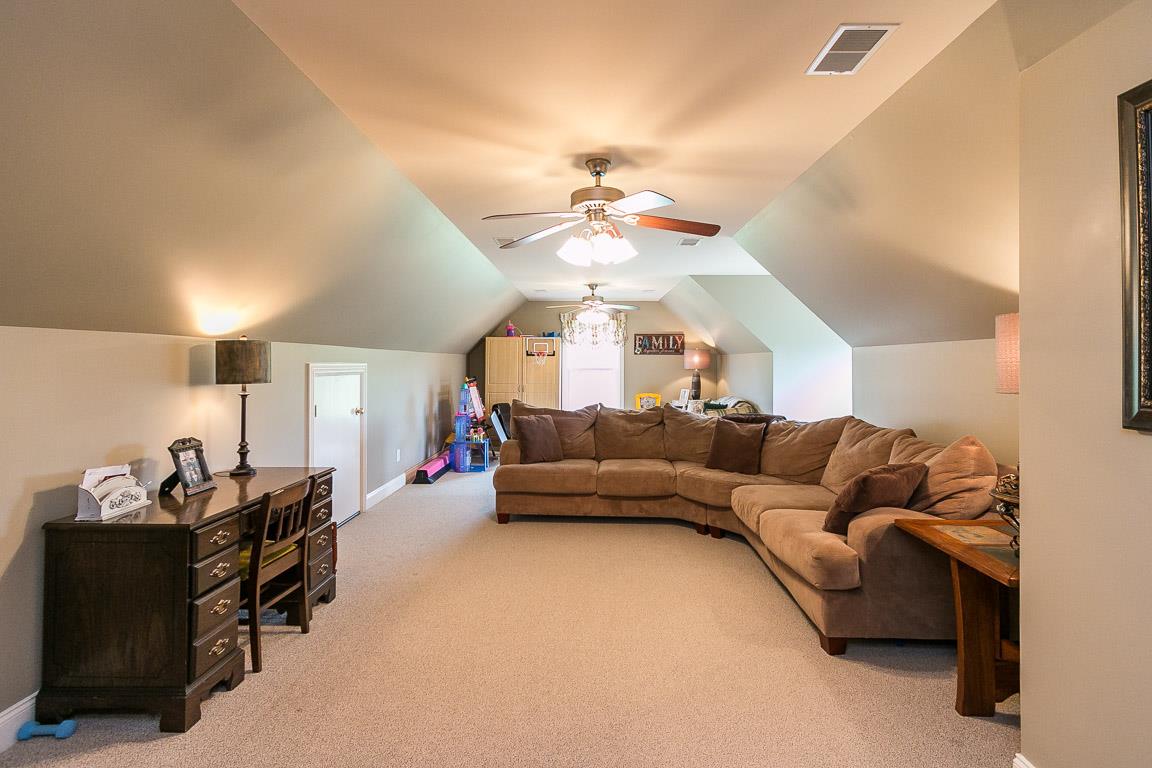 1232 Sugar Flat Road Lebanon, TN 37087 - Photo 29 of 30 a living room with furniture and a chandelier
