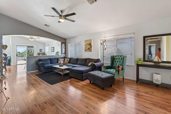 a living room with furniture a fireplace and wooden floor