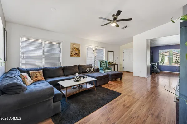 a living room with furniture and wooden floor