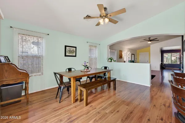 a view of a dining room with furniture and wooden floor