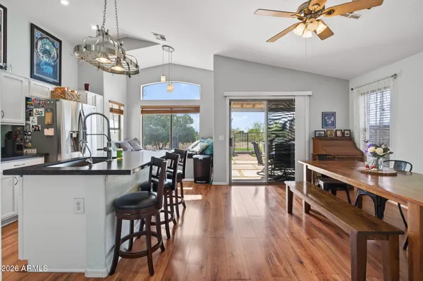 a very nice looking dining room with wooden floor and furniture