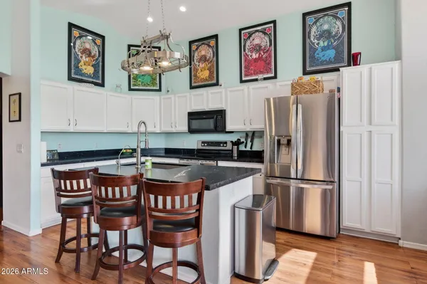 a kitchen with stainless steel appliances granite countertop a refrigerator and a stove top oven