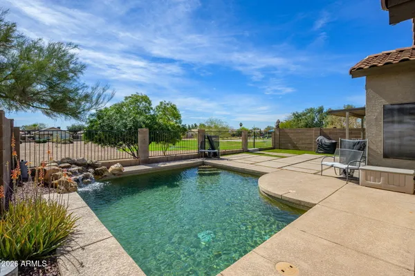 a view of a swimming pool with lounge chairs