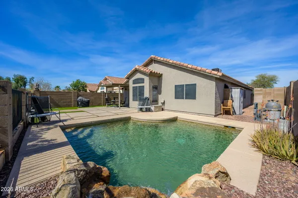 a view of a house with a yard patio and swimming pool