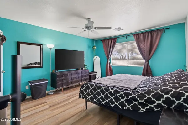 a bedroom with a bed and a flat screen tv