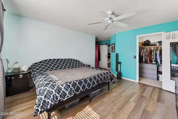 a bedroom with a bed and a chandelier