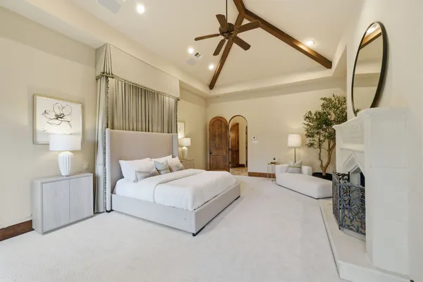 a bedroom with furniture and a fireplace