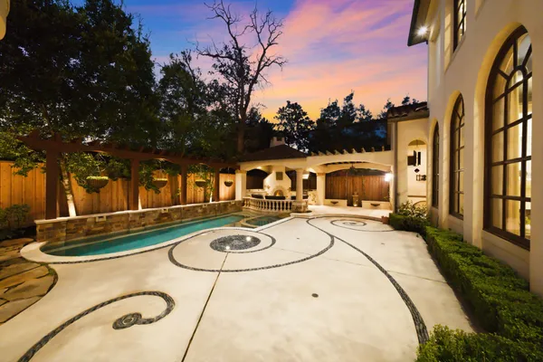 a view of a backyard with table and chairs with wooden fence