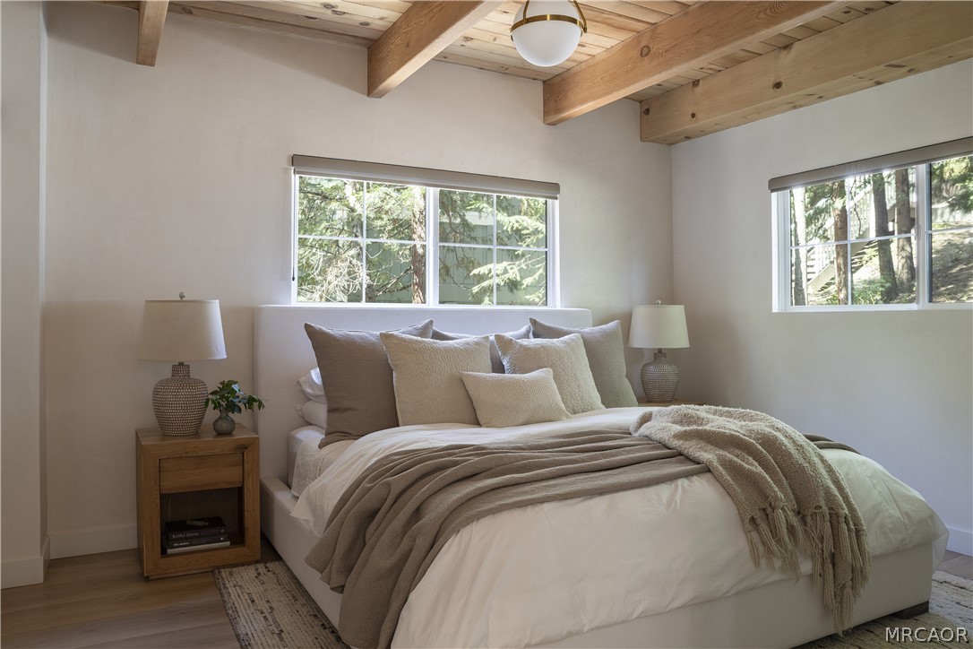 27643 West Shore Road, Unit 1 Lake Arrowhead, CA 92352 - Photo 12 of 28 a bed sitting in a bedroom next to a window