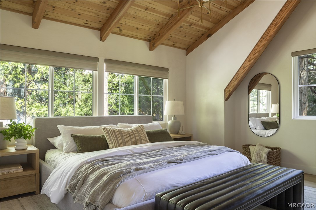 27643 West Shore Road, Unit 1 Lake Arrowhead, CA 92352 - Photo 18 of 28 a bedroom with a bed a mirror on dresser and a large window