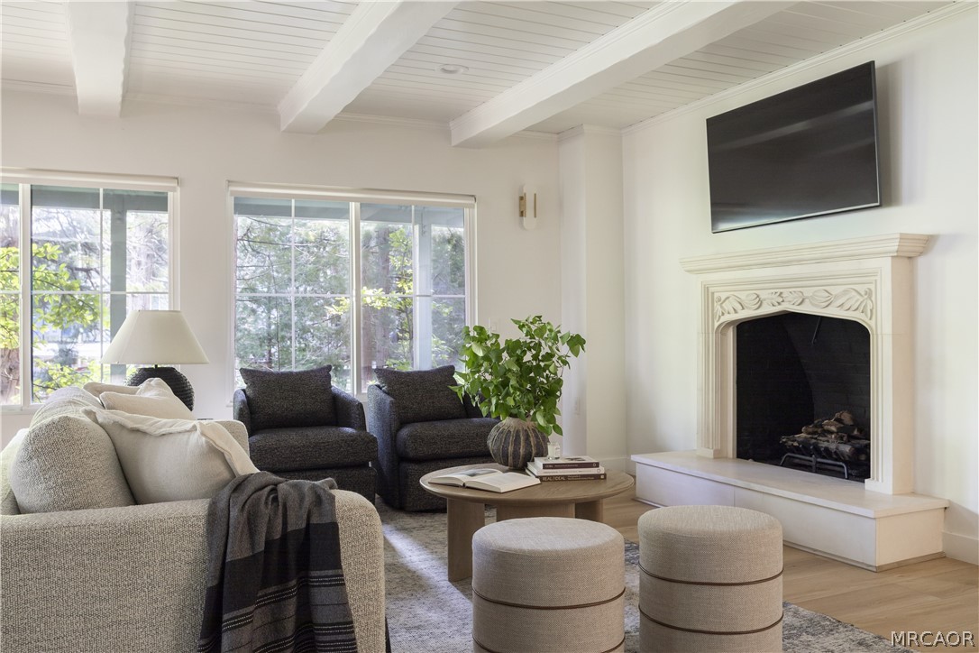 27643 West Shore Road, Unit 1 Lake Arrowhead, CA 92352 - Photo 21 of 28 a living room with furniture a fireplace and a flat screen tv