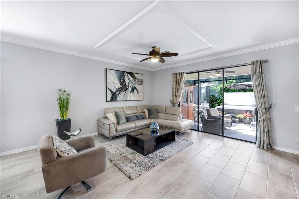 4244 Raffia Palm Circle Naples, FL 34119 - Photo 14 of 38 a living room with furniture and a window