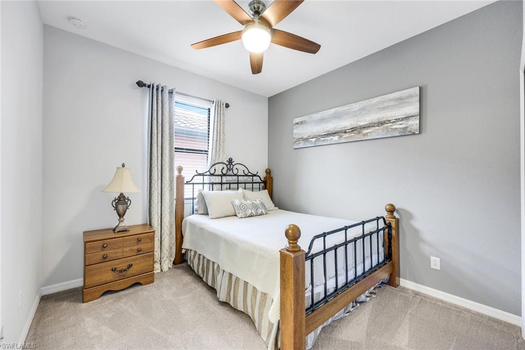 4244 Raffia Palm Circle Naples, FL 34119 - Photo 21 of 38 a bedroom with a bed and a window