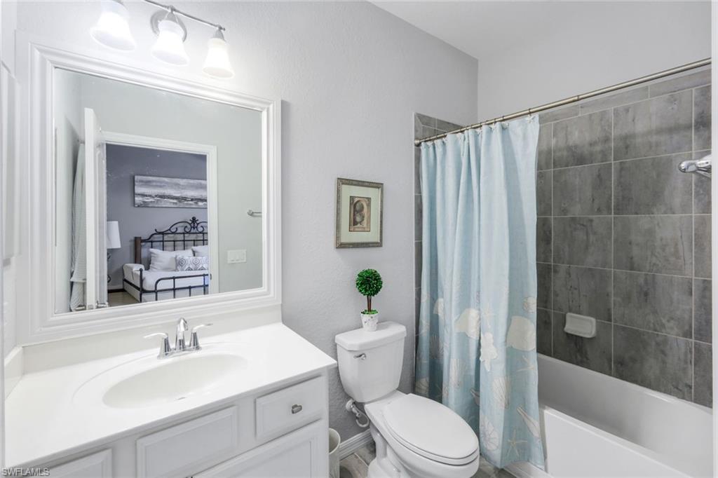 4244 Raffia Palm Circle Naples, FL 34119 - Photo 22 of 38 a bathroom with a sink a toilet and shower