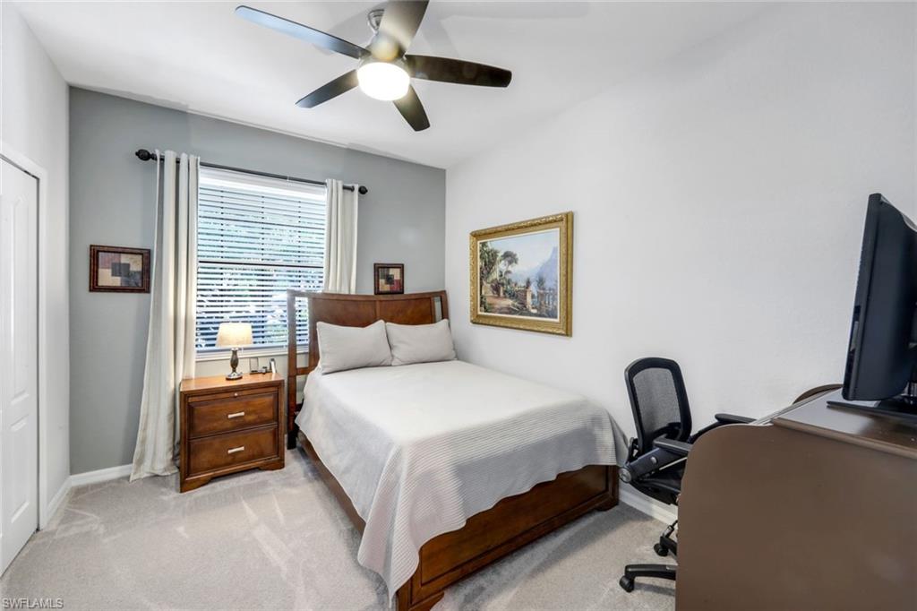 4244 Raffia Palm Circle Naples, FL 34119 - Photo 23 of 38 a bedroom with a bed and a large window