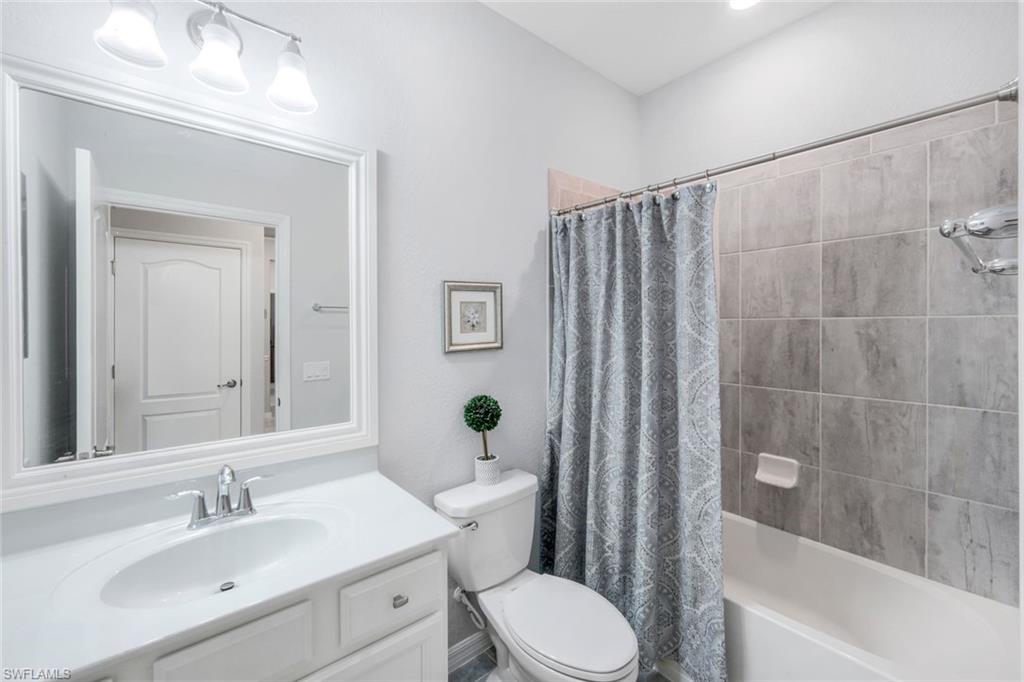 4244 Raffia Palm Circle Naples, FL 34119 - Photo 24 of 38 a bathroom with a sink a toilet and shower
