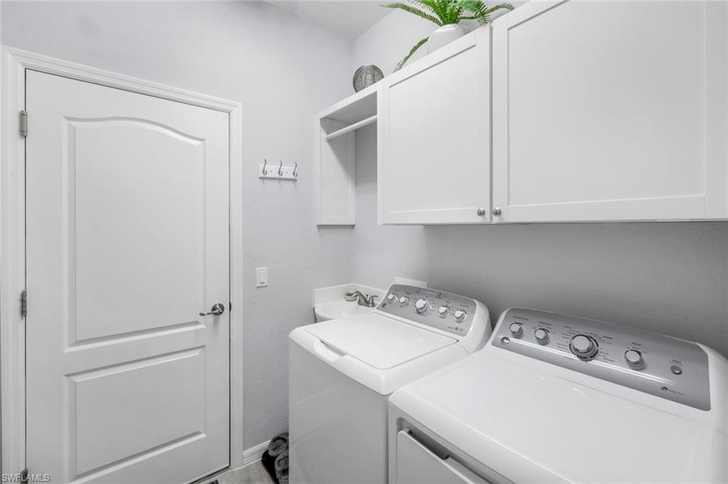 4244 Raffia Palm Circle Naples, FL 34119 - Photo 25 of 38 a utility room with dryer and washer