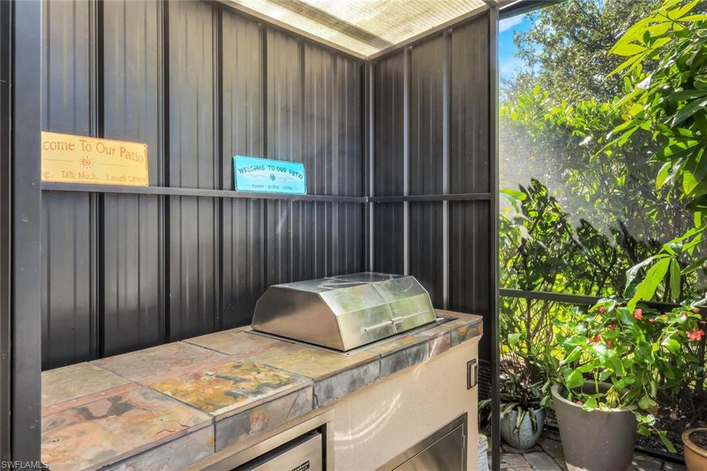 4244 Raffia Palm Circle Naples, FL 34119 - Photo 30 of 38 a bath tub sitting in a kitchen with a window