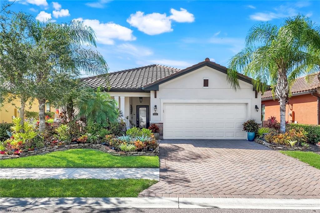 4244 Raffia Palm Circle Naples, FL 34119 - Photo 38 of 38 a front view of a house with a garden