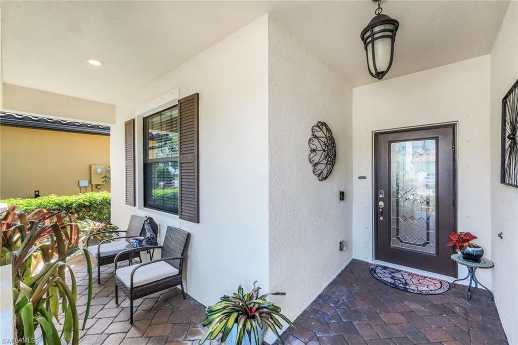 4244 Raffia Palm Circle Naples, FL 34119 - Photo 4 of 38 a bedroom with furniture and a window